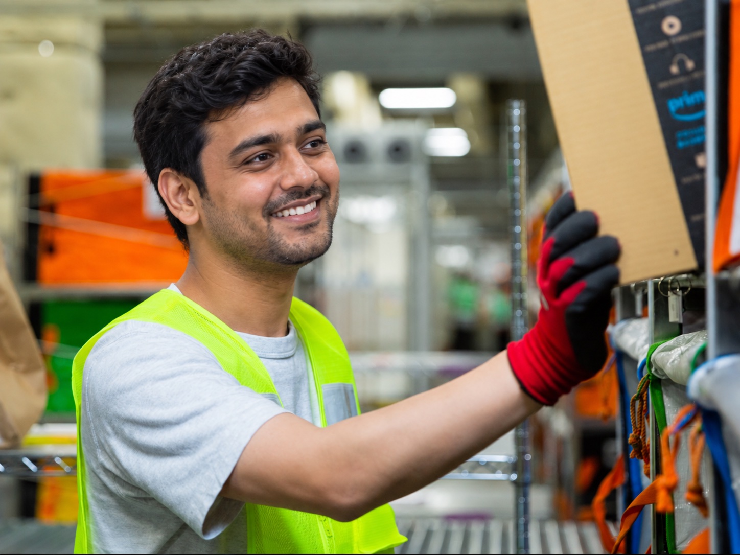Warehouse staff member placing a parcel on a shelf